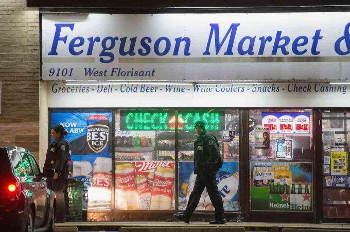 Des agents de police devant le Ferguson Market & Liquor lors des émeutes de 2014 à Ferguson, Missouri.